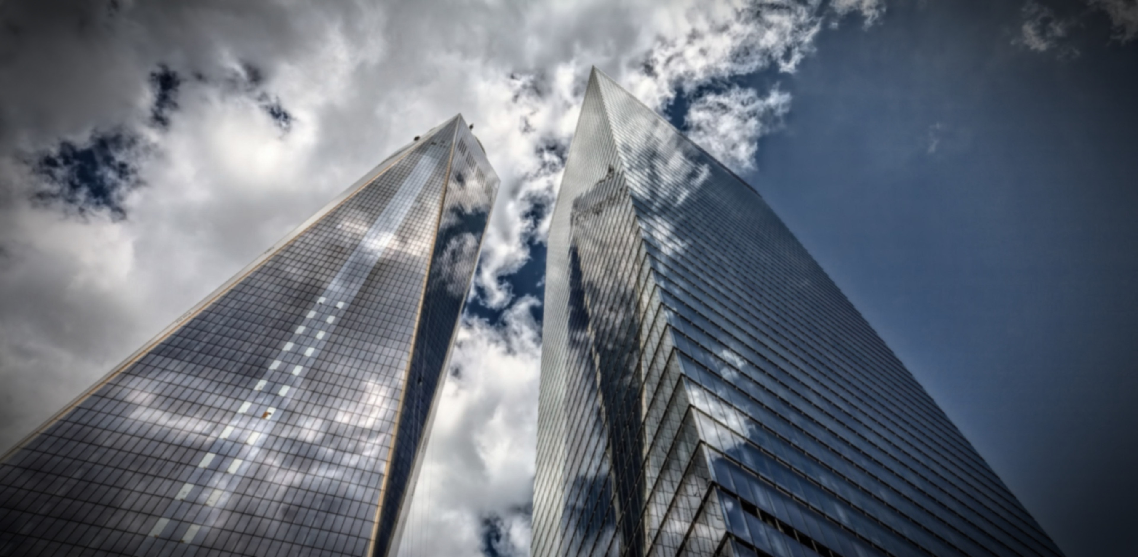 Two skyscrapers standing against the blue sky