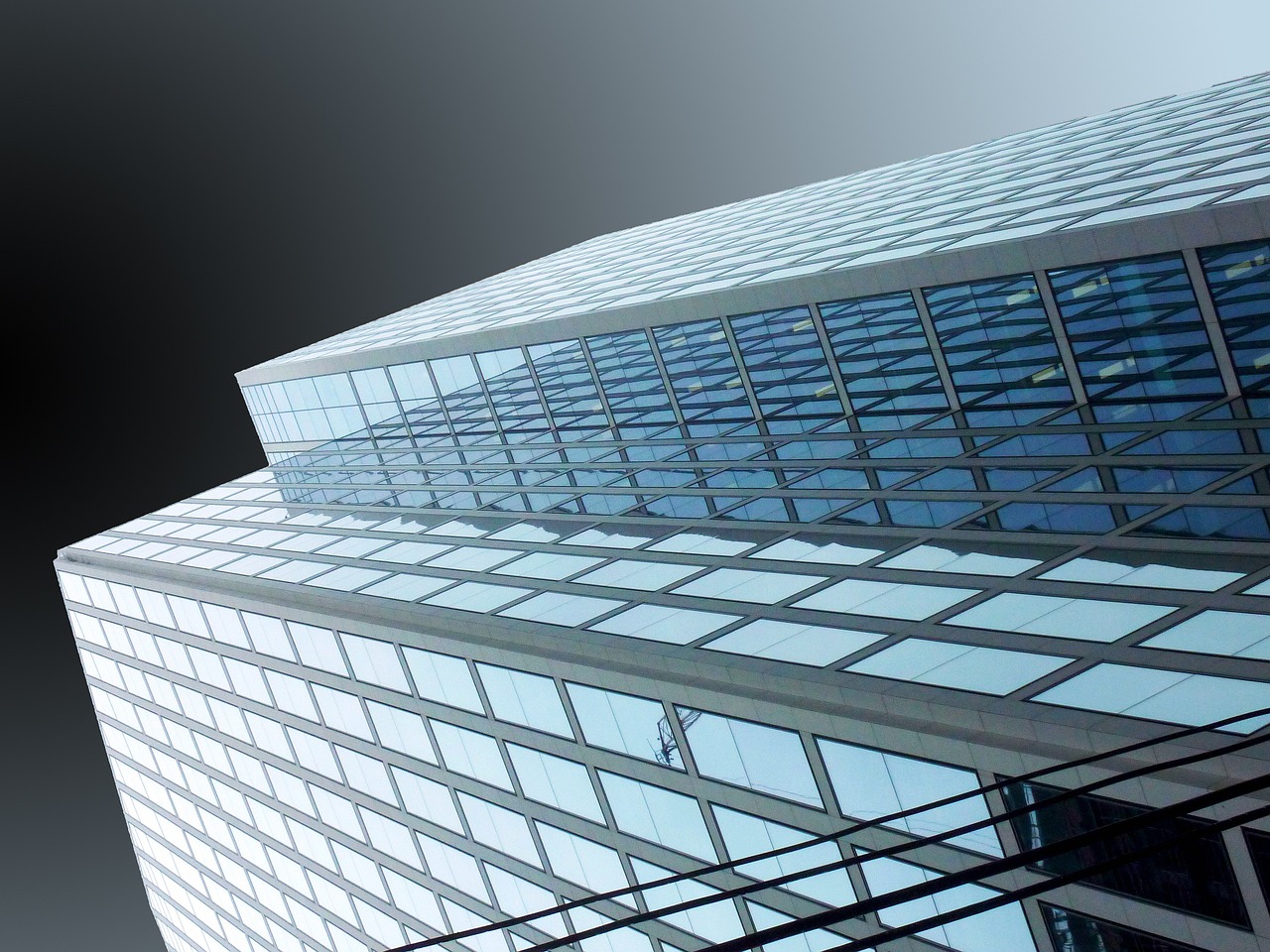 A building on an angle with a black sky